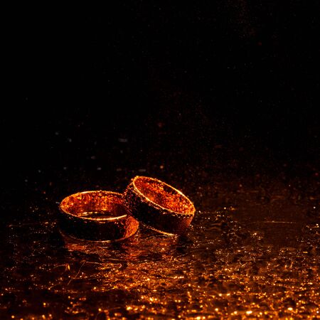 Beautiful gold wedding rings with water dropsの写真素材