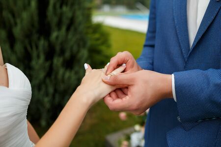 Newlyweds put each other rings on the ceremonyの写真素材