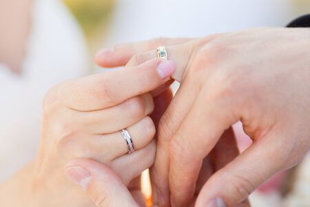 Newlyweds put each other rings on the ceremonyの写真素材