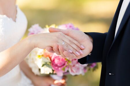 Newlyweds put each other rings on the ceremonyの写真素材