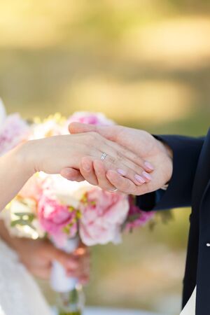Newlyweds put each other rings on the ceremonyの写真素材