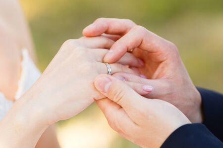 Newlyweds put each other rings on the ceremonyの写真素材