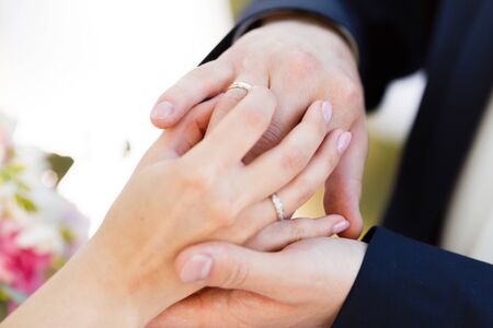 Newlyweds put each other rings on the ceremonyの写真素材