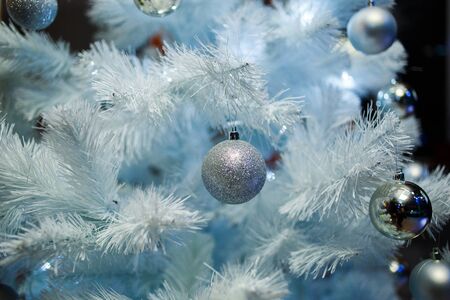 Christmas balls on a white fluffy Christmas treeの写真素材