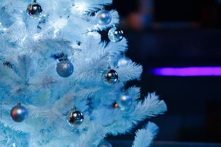 Christmas balls on a white fluffy Christmas treeの写真素材