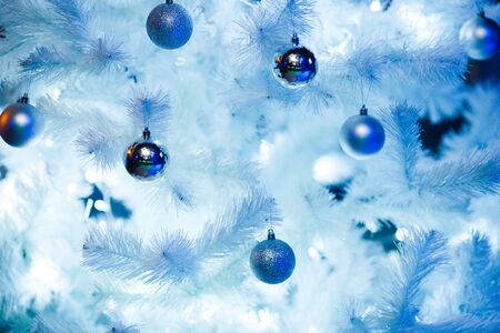 Christmas balls on a white fluffy Christmas treeの写真素材