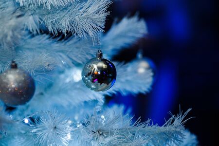 Christmas balls on a white fluffy Christmas treeの写真素材