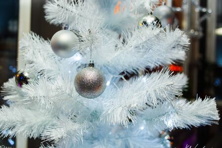 Christmas balls on a white fluffy Christmas treeの写真素材