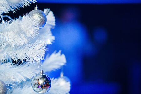 Christmas balls on a white fluffy Christmas treeの写真素材