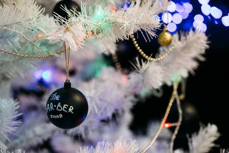White christmas tree with black Christmas balls and decoration in barber shop.の写真素材