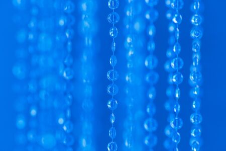 Electric blue abstract sparkler background, defocused Christmas lights. Festive concept. Selective focus.の写真素材