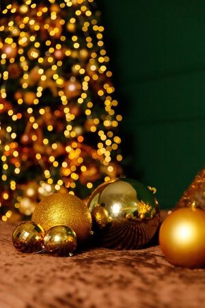 Golden Christmas Balls And Decorations From A Beautiful Christmas Tree. Decorated Christmas Interior in golden colour. Place For Text.の写真素材