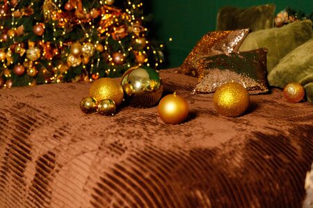Golden Christmas Balls And Decorations From A Beautiful Christmas Tree. Decorated Christmas Interior in golden colour. Place For Text.の写真素材