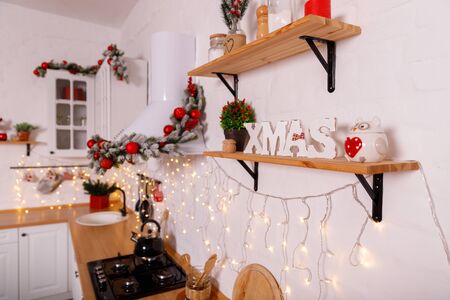 Christmas decorated kithen in loft style. Red colors. Modern loft style of interior dacorated for New Year Eveの写真素材