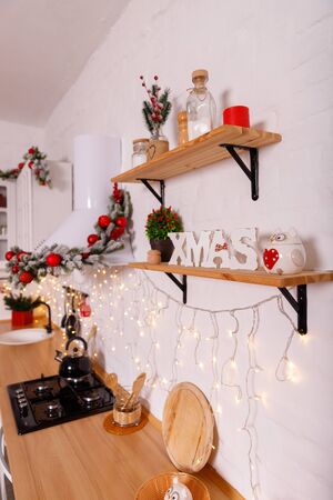 Christmas decorated kithen in loft style. Red colors. Modern loft style of interior dacorated for New Year Eveの写真素材