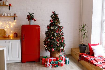 Christmas decorated kithen in loft style. Red colors. Modern loft style of interior dacorated for New Year Eveの写真素材