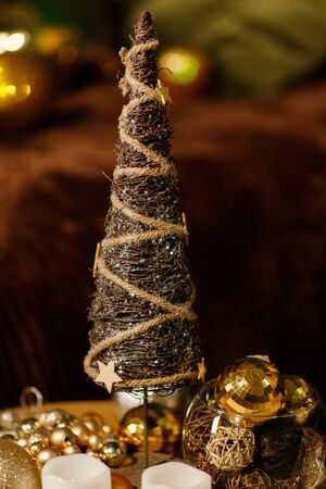 Christmas tree in the room decorated with toys and lay next to the gifts in boxesの写真素材