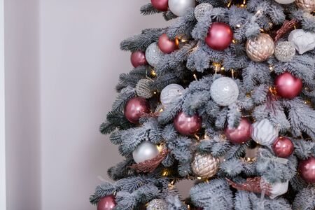 Christmas tree in the room decorated with toys and lay next to the gifts in boxesの写真素材