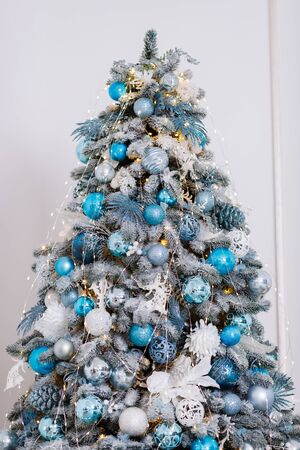 Christmas tree in the room decorated with toys and lay next to the gifts in boxesの写真素材