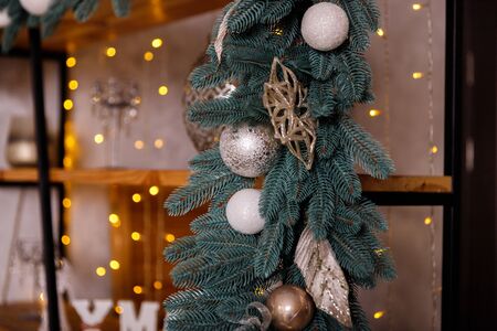 Beautiful New Year Tree decorated with colorful packed gifts and balls in studio against white background with empty space for Christmas text postcard concept.の写真素材