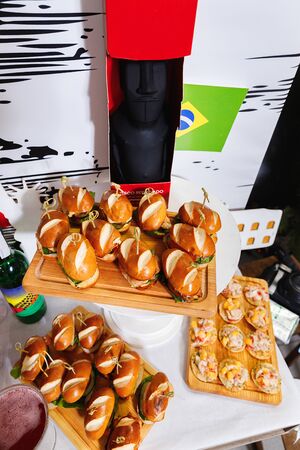 Small chicken burgers served on wooden chopping boardの写真素材