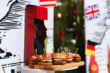 Small chicken burgers served on wooden chopping boardの写真素材