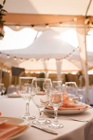Glasses for wine and champagne on a served table at a banquetの写真素材
