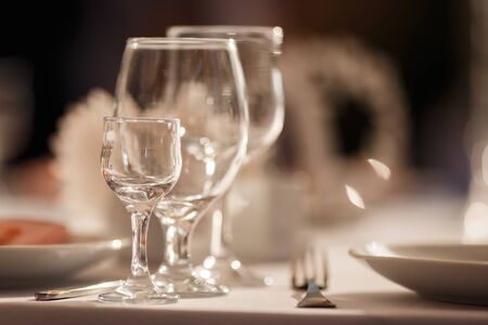 Glasses for wine and champagne on a served table at a banquetの写真素材