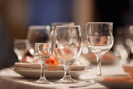 Glasses for wine and champagne on a served table at a banquet
