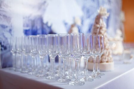Empty glasses for wine and champagne in a row at the banquet tableの写真素材