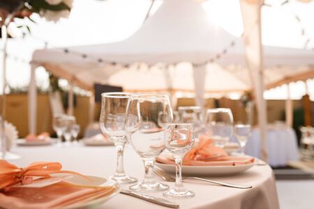 Glasses for wine and champagne on a served table at a banquetの写真素材