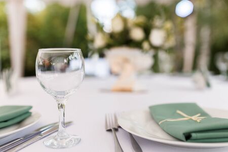 Glasses for wine and champagne on a served table at a banquetの写真素材