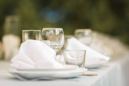 Glasses for wine and champagne on a served table at a banquet
