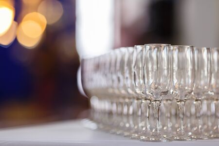 Empty glasses for wine and champagne in a row at the banquet tableの写真素材