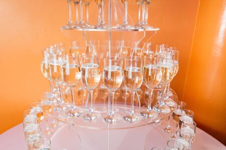 Glasses of champagne and sparkling wine served at charity event, alcoholic drinks close-up.の写真素材