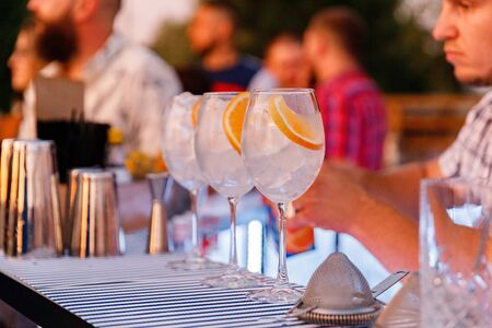 The process of making a cocktail with ice and orange juice