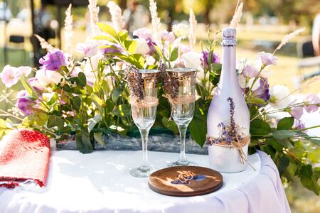 Glasses with champagne on the table for the bride and groom at the engagement ceremonyの写真素材