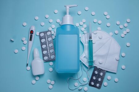 Protective equipment and medicines from coronavirus COVID-19 on a medical blue backgroundの写真素材