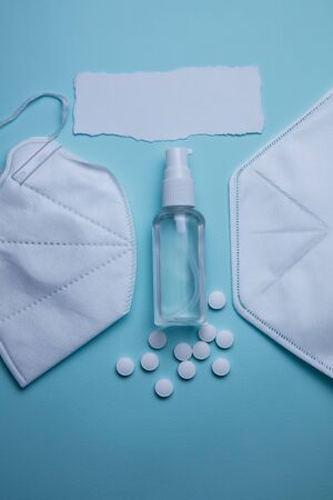 pills, sanitizer and protective mask on a blue background. Concept of medicine. Prevention of coronavirus.の写真素材