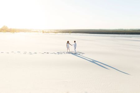 Wedding Newlyweds run barefoot through the White Desert.の写真素材