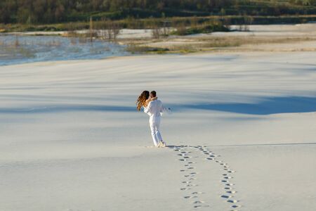 Wedding Newlyweds run barefoot through the White Desert.の写真素材