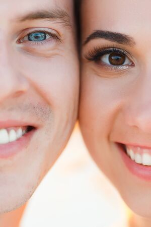 Male and female half face looking into camera and smile.の写真素材