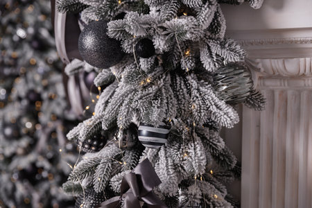 Black and white Christmas decoration on a snow-covered tree branch.の写真素材
