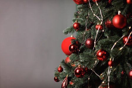 Red Christmas balls decorate a Christmas tree. Selective focus.の写真素材
