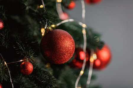 Red Christmas balls decorate a Christmas tree. Selective focus.の写真素材