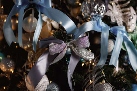 Christmas tree with blue, white and silver balls on it.の写真素材