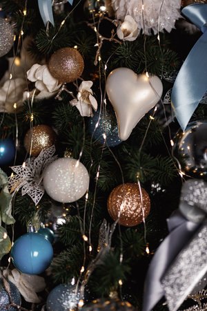 Christmas blue, white and silver balls and toys hanging on a Christmas tree.の写真素材