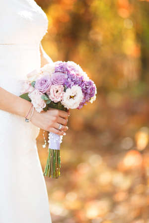 the bride holds the bouquet of flowers in her hand, the wedding floral bouquetの写真素材