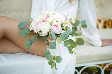 the bride holds the bouquet of flowers in her hand, the wedding floral bouquetの写真素材