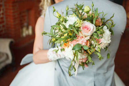 the bride holds the bouquet of flowers in her hand, the wedding floral bouquetの写真素材